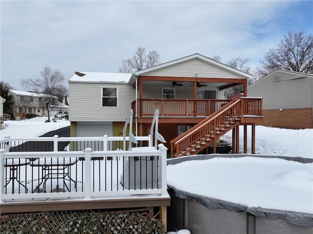 snow covered house with ceiling fan and a deck