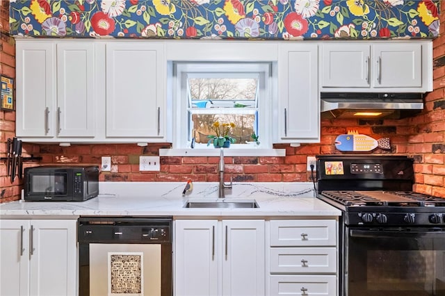 kitchen with sink, white cabinets, light stone counters, and black appliances