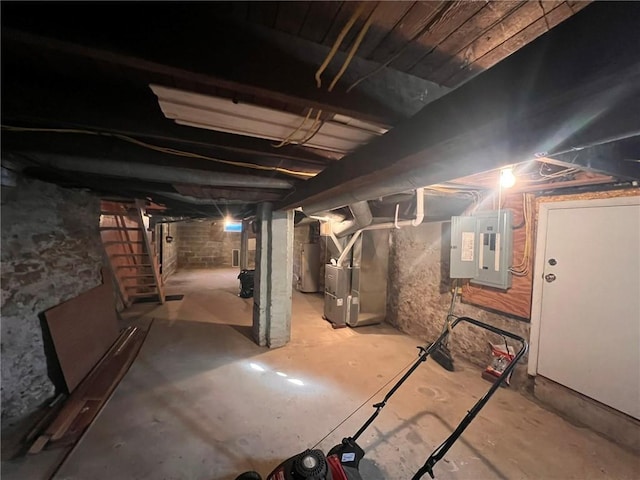 unfinished basement with heating unit and electric panel