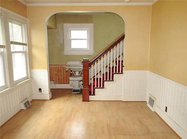 147 Carmichaels St, Dry Tav/Rices Landing, PA 15357 - stairs featuring a wainscoted wall, arched walkways, wood finished floors, and ornamental molding