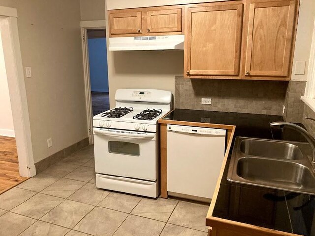 kitchen with sink, white appliances, decorative backsplash, and light tile patterned floors