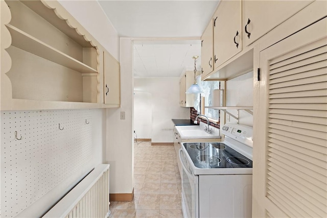 kitchen featuring electric stove, sink, and light tile patterned floors