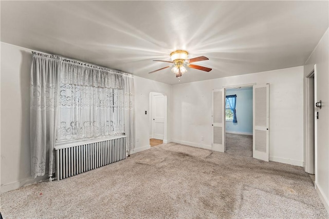 empty room featuring ceiling fan and carpet flooring