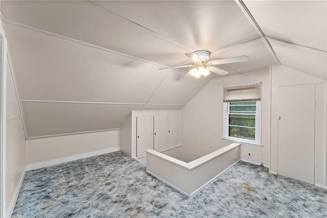 bonus room with vaulted ceiling, light colored carpet, and ceiling fan