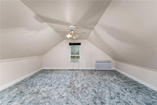 additional living space featuring ceiling fan, lofted ceiling, radiator, and carpet floors