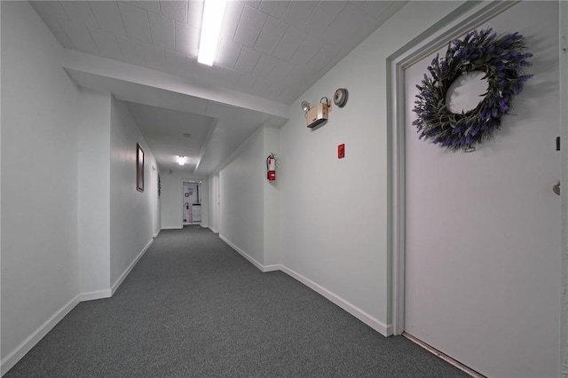 hallway featuring dark carpet