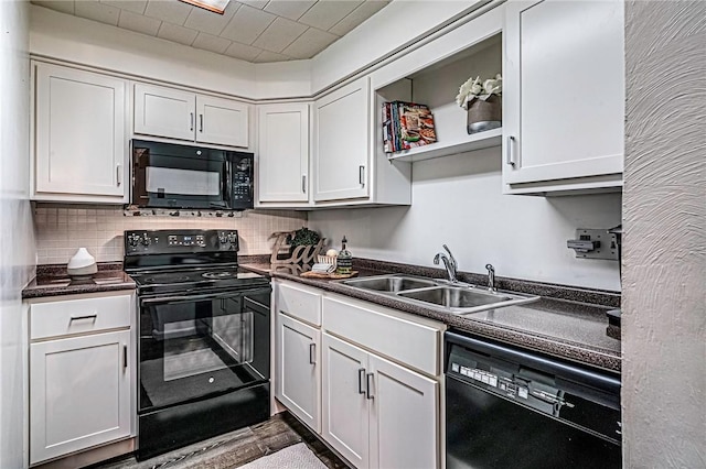 kitchen featuring white cabinetry, sink, decorative backsplash, and black appliances