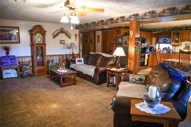 living room with ceiling fan, carpet, and a textured ceiling