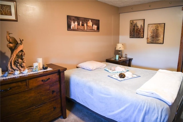 carpeted bedroom featuring a textured ceiling