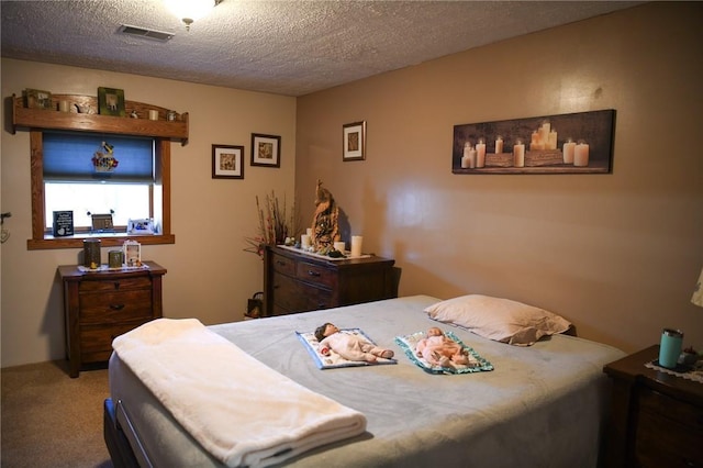 carpeted bedroom featuring a textured ceiling