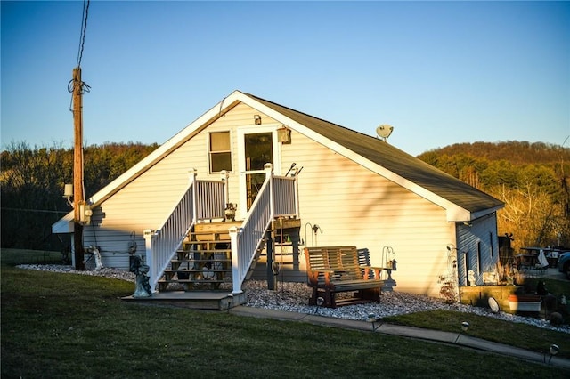 rear view of house featuring a yard