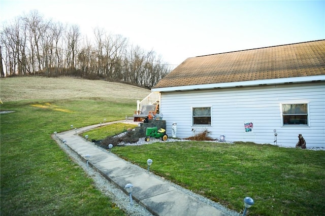 view of side of home with a lawn