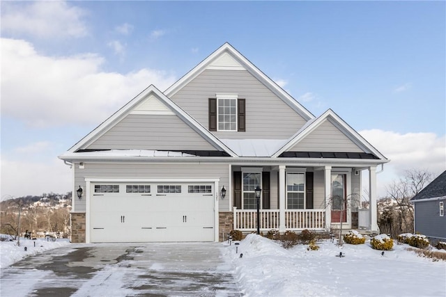 craftsman inspired home featuring a garage and a porch