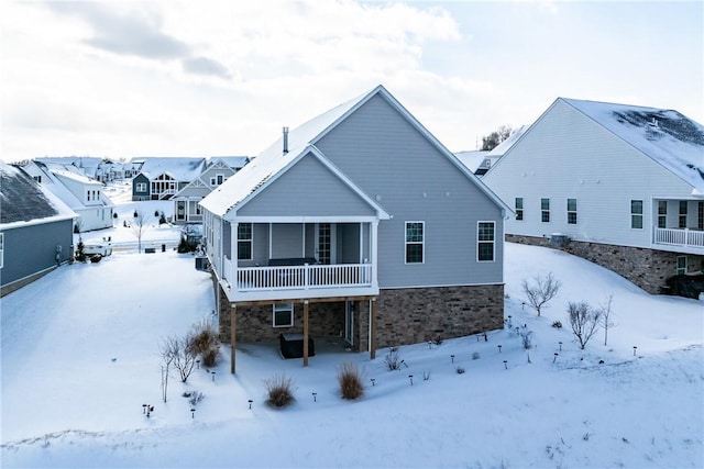 view of snow covered rear of property