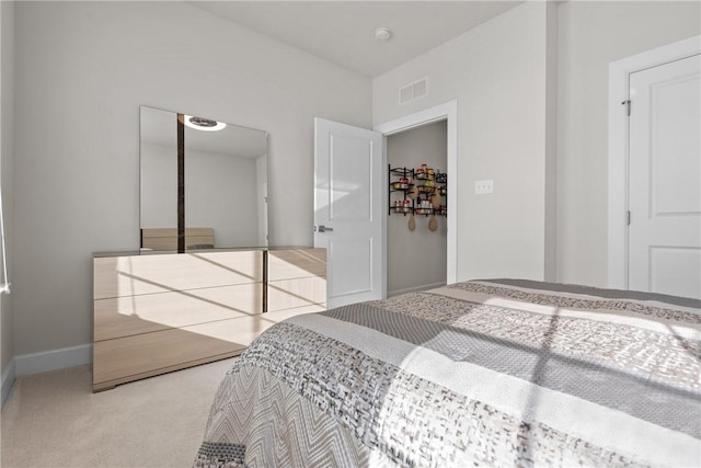 bedroom featuring light colored carpet