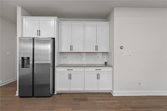 kitchen with stainless steel refrigerator with ice dispenser, white cabinets, and dark hardwood / wood-style flooring