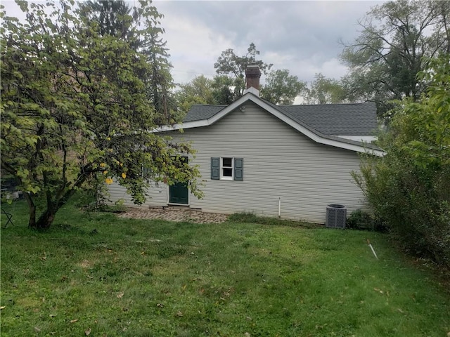 exterior space featuring a yard and central AC unit