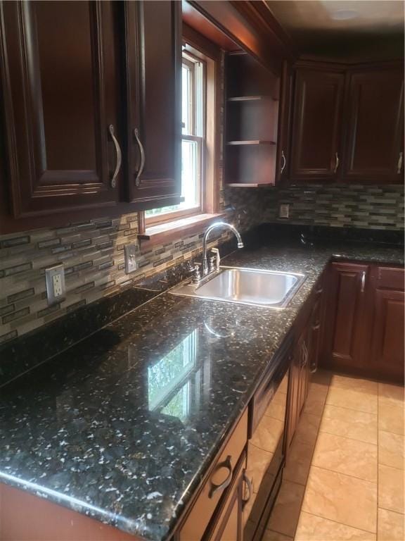 kitchen with dishwasher, sink, dark stone countertops, backsplash, and light tile patterned floors