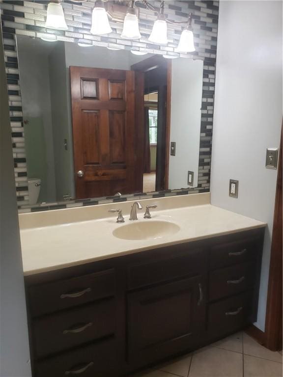 bathroom with vanity, tile patterned floors, and toilet