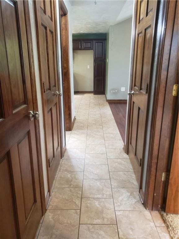 corridor featuring light tile patterned flooring