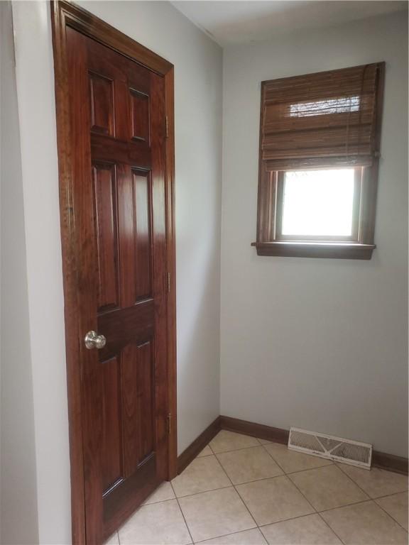 doorway featuring light tile patterned flooring