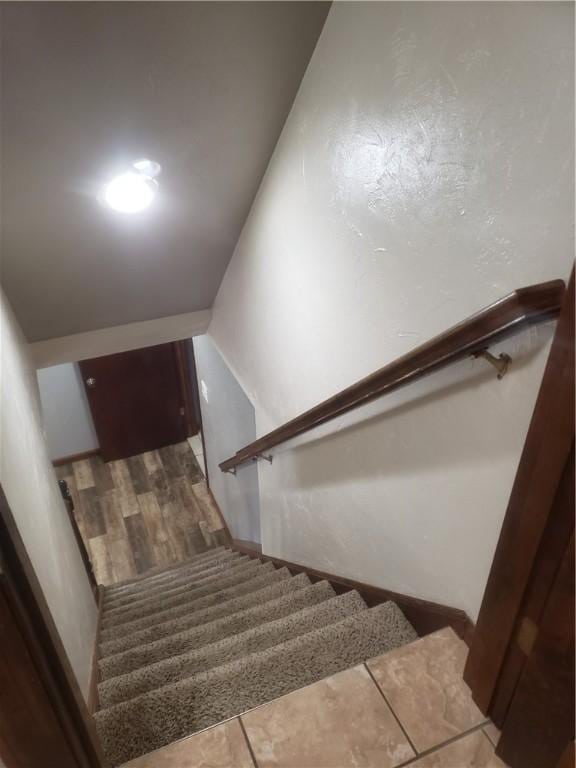 stairway with hardwood / wood-style floors