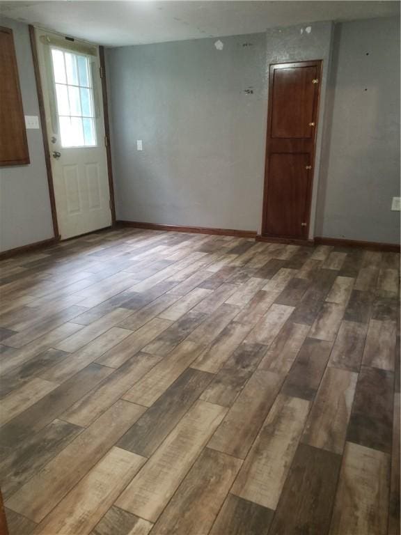 unfurnished room featuring dark hardwood / wood-style flooring