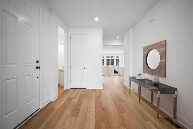 hallway with light hardwood / wood-style flooring