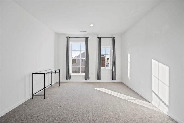 unfurnished room with light colored carpet