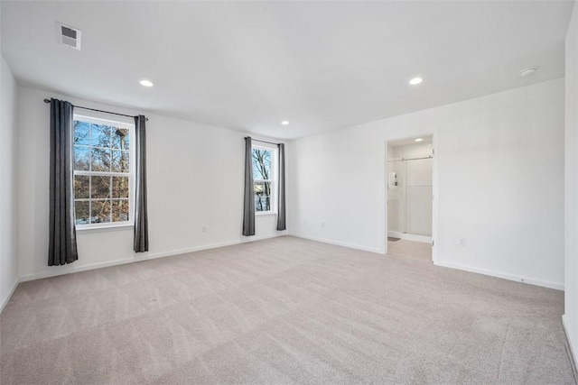 unfurnished room featuring light colored carpet