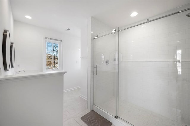 bathroom featuring a shower with shower door and tile patterned flooring