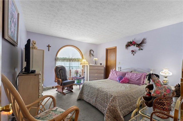 bedroom with carpet floors and a textured ceiling