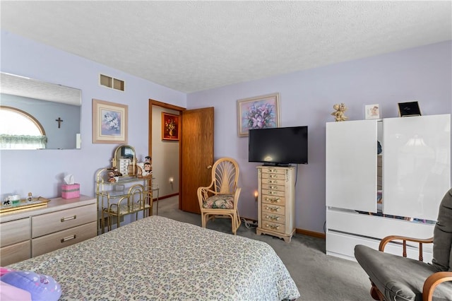 bedroom featuring carpet floors and a textured ceiling