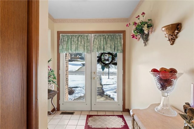 doorway with light tile patterned floors and french doors