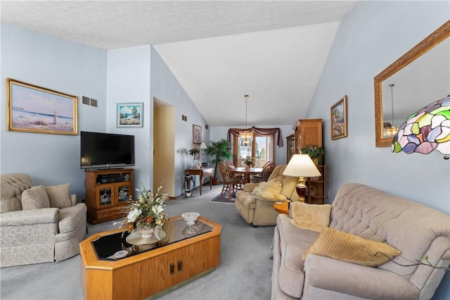 carpeted living room featuring lofted ceiling and a textured ceiling