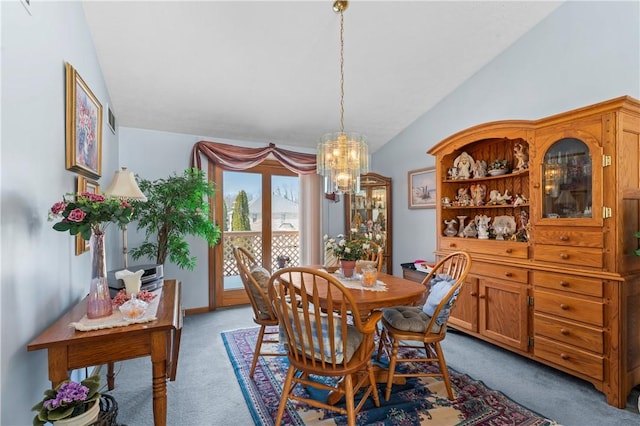 dining space featuring lofted ceiling, light colored carpet, and a chandelier