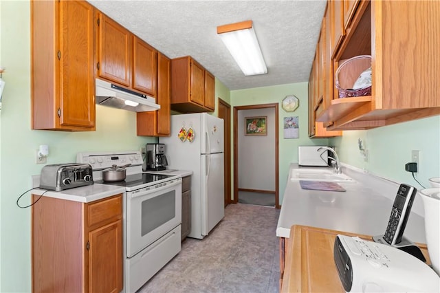 kitchen featuring sink, a textured ceiling, and white appliances