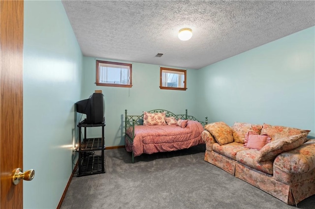 carpeted bedroom with a textured ceiling