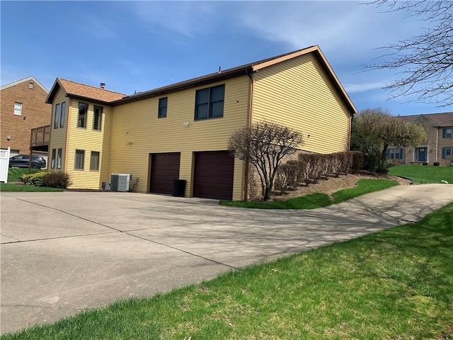 105 Lawrence Dr, Brighton Twp, PA 15009 - view of home's exterior featuring central AC unit, an attached garage, and concrete driveway