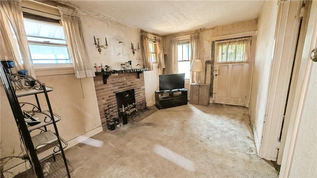 living room with a brick fireplace