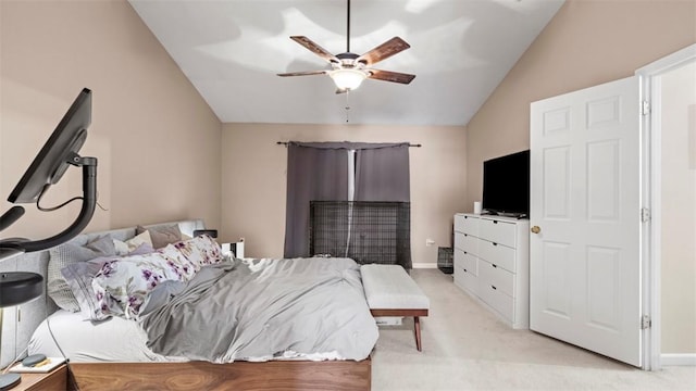 bedroom with vaulted ceiling, light colored carpet, and ceiling fan