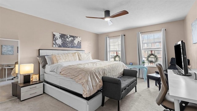 bedroom with ceiling fan and light carpet