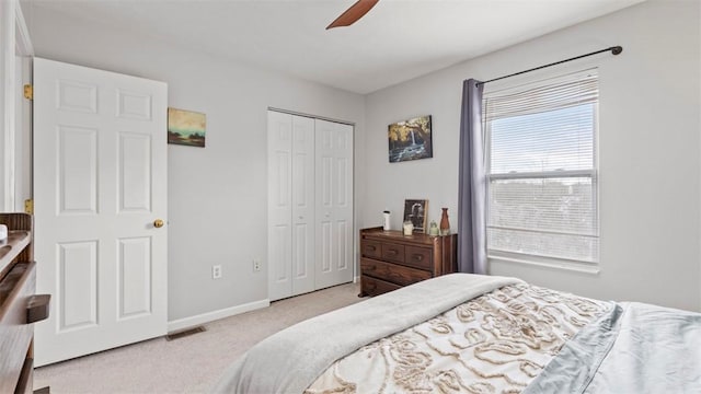 carpeted bedroom with ceiling fan and a closet