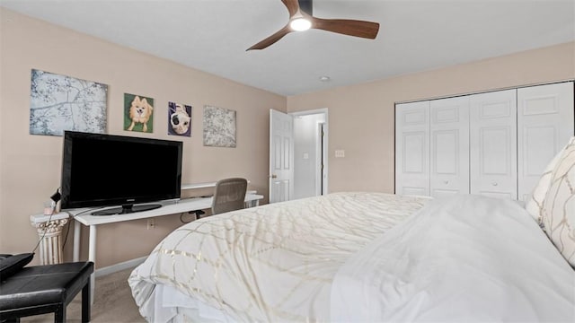 carpeted bedroom with ceiling fan and a closet