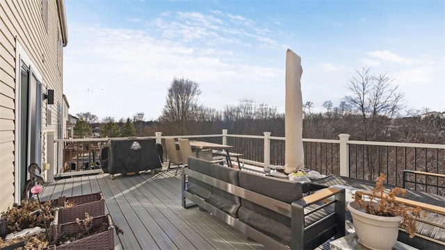 wooden deck featuring a grill