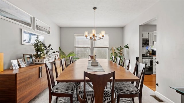 dining space with a notable chandelier