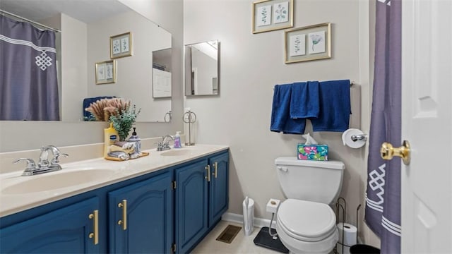 bathroom featuring vanity and toilet