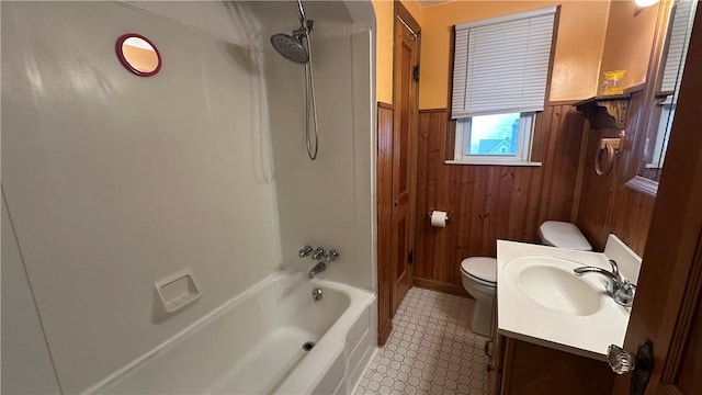 full bathroom featuring vanity, wooden walls, shower / tub combination, and toilet