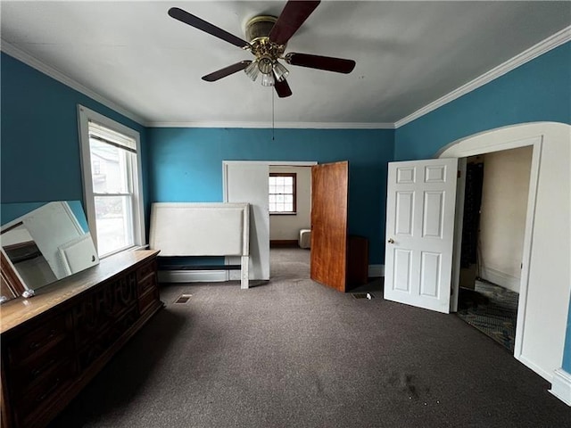 unfurnished bedroom with crown molding and dark carpet