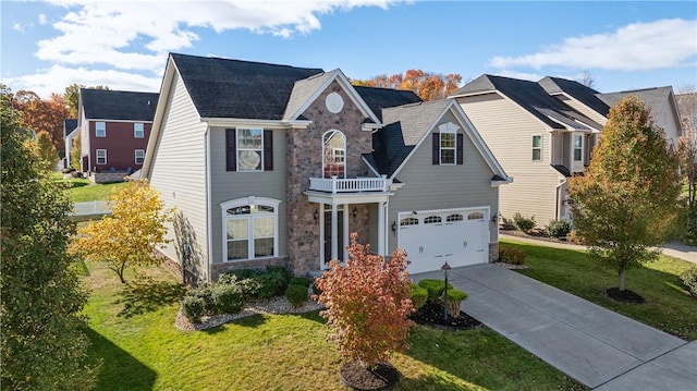 view of front of property with a balcony, a garage, and a front yard